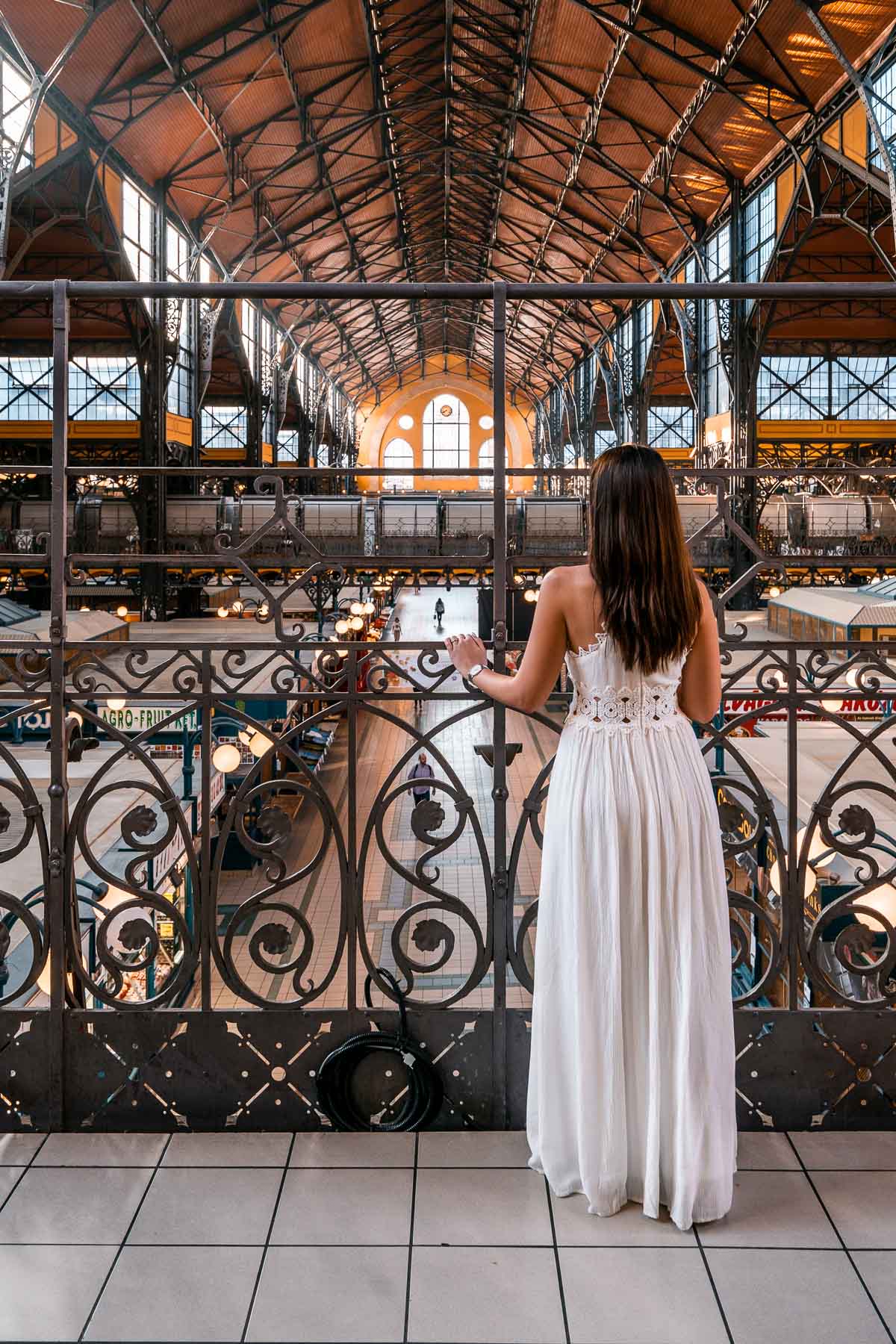 Girl in a white dress standing in the Great Market Hall in Budapest