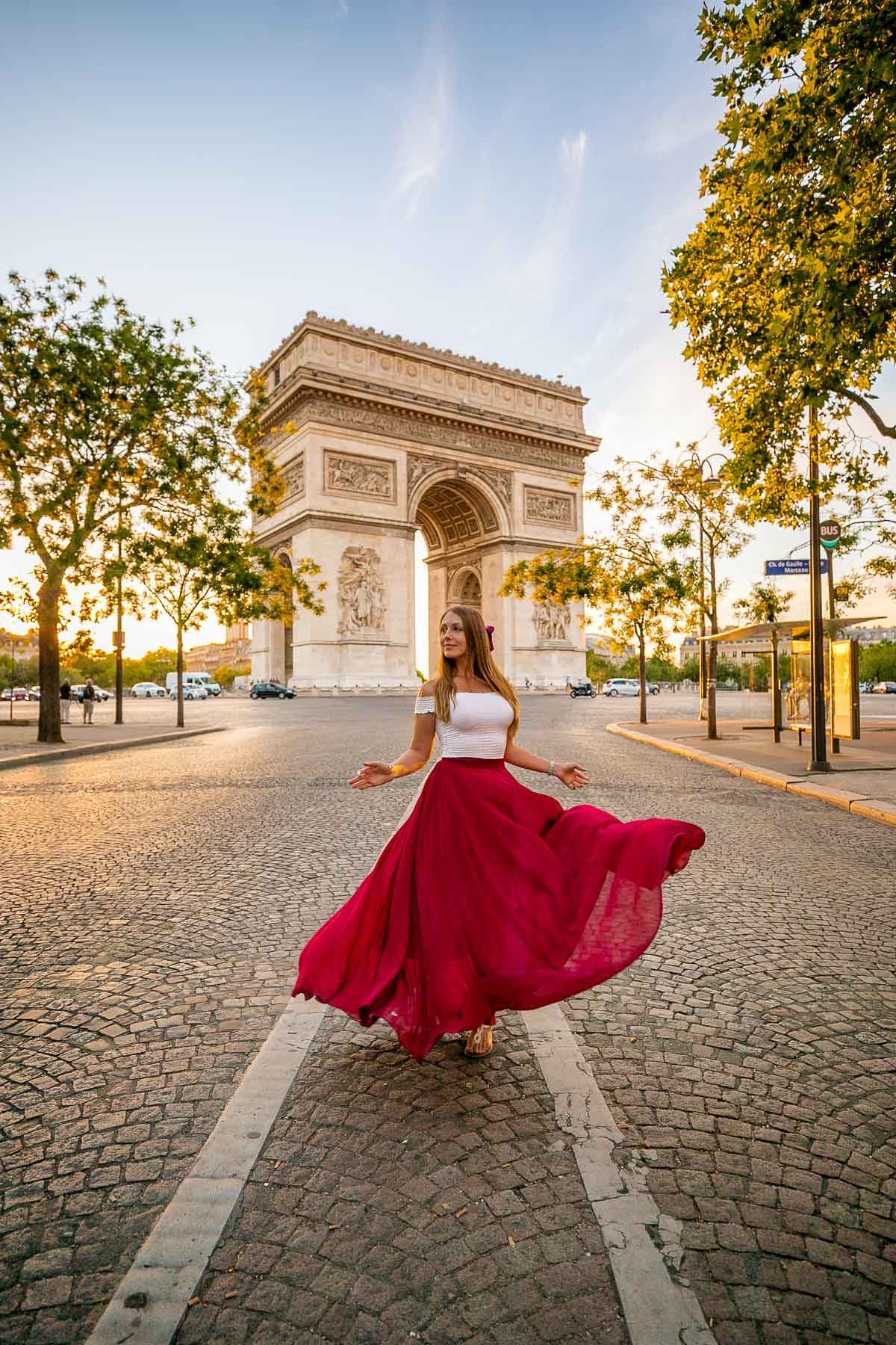 Girl in a red skirt in front of Arc de Triomphe, Paris
