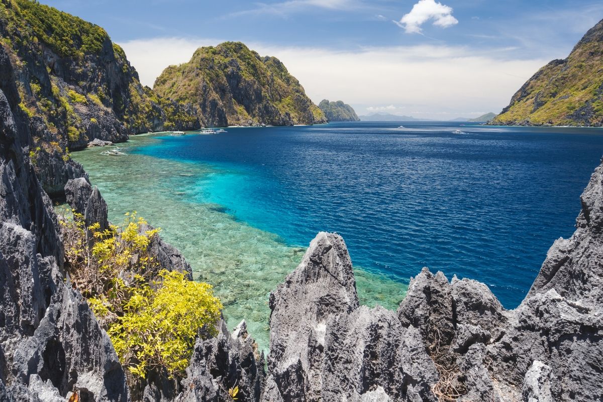 Cliffs and blue water on Matinloc island, Philippines