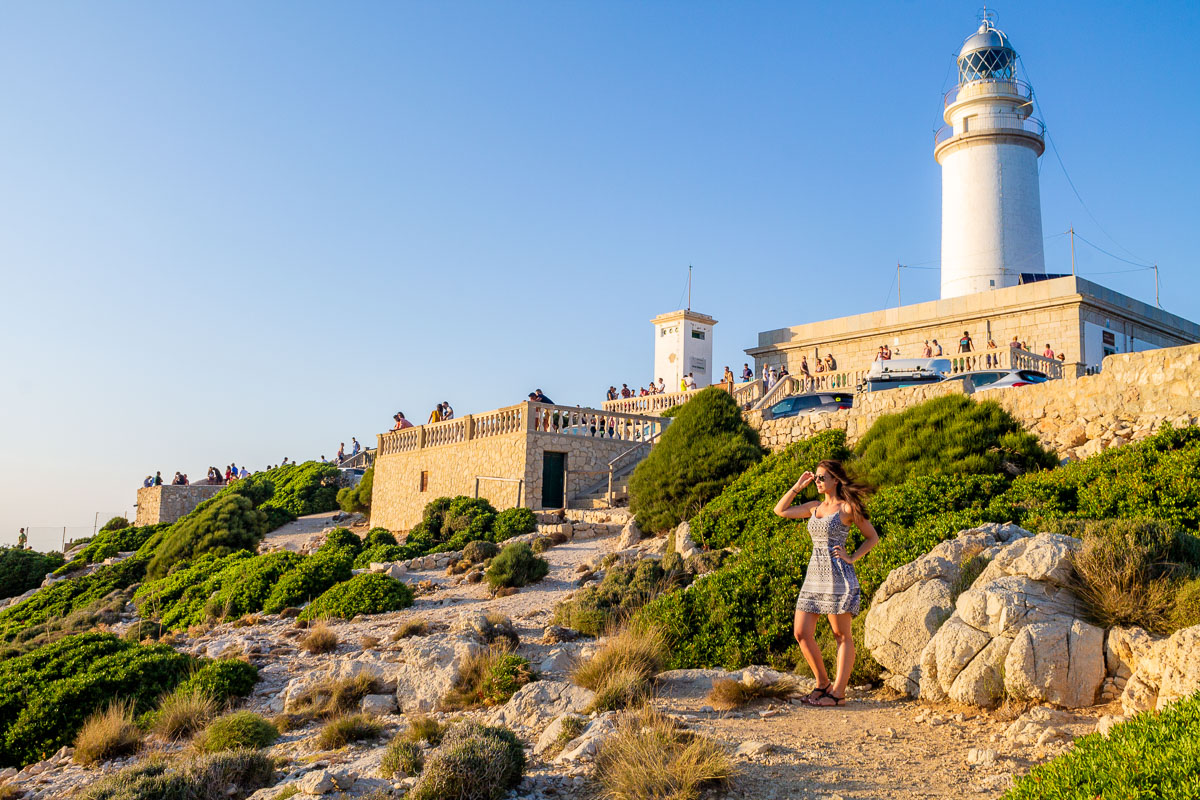 Girl standing in front of the lighthouse at Cap de Formentor in Mallorca
