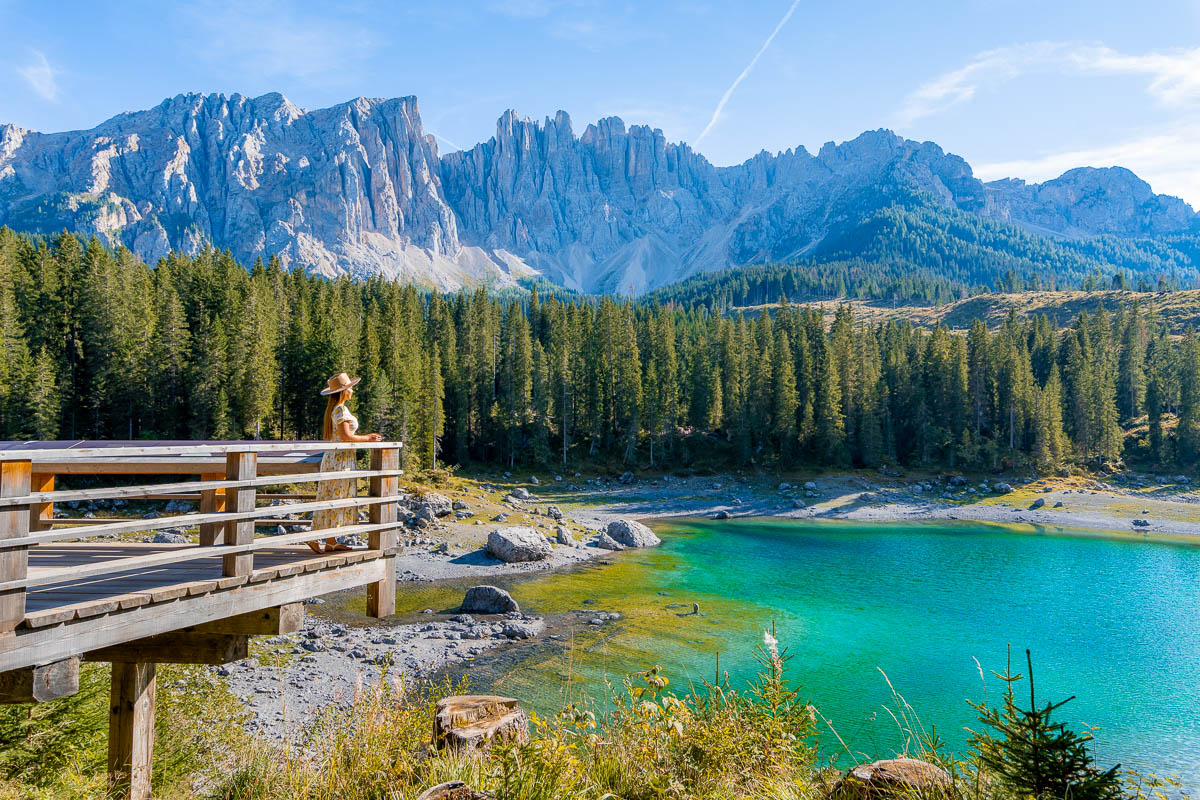 Girl at Lago di Carezza, one of the best lakes in the Dolomites