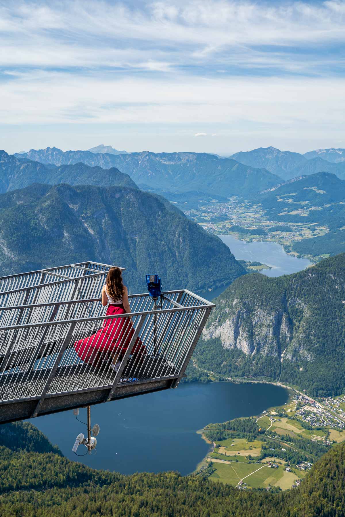 Girl in a red skirt standing on the 5 Fingers Viewing Platform in Austria