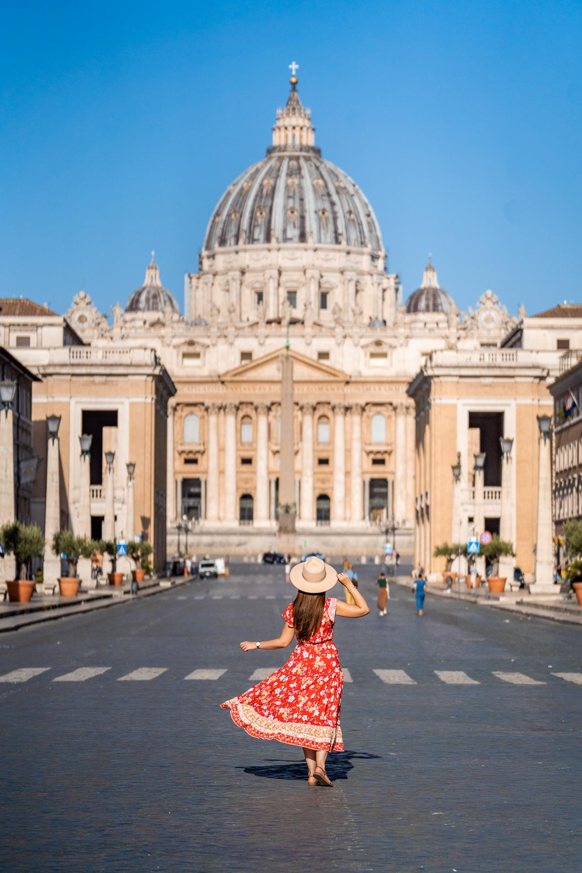 Girl in a red dress in front of St. Peter's Basilica, Vatican City