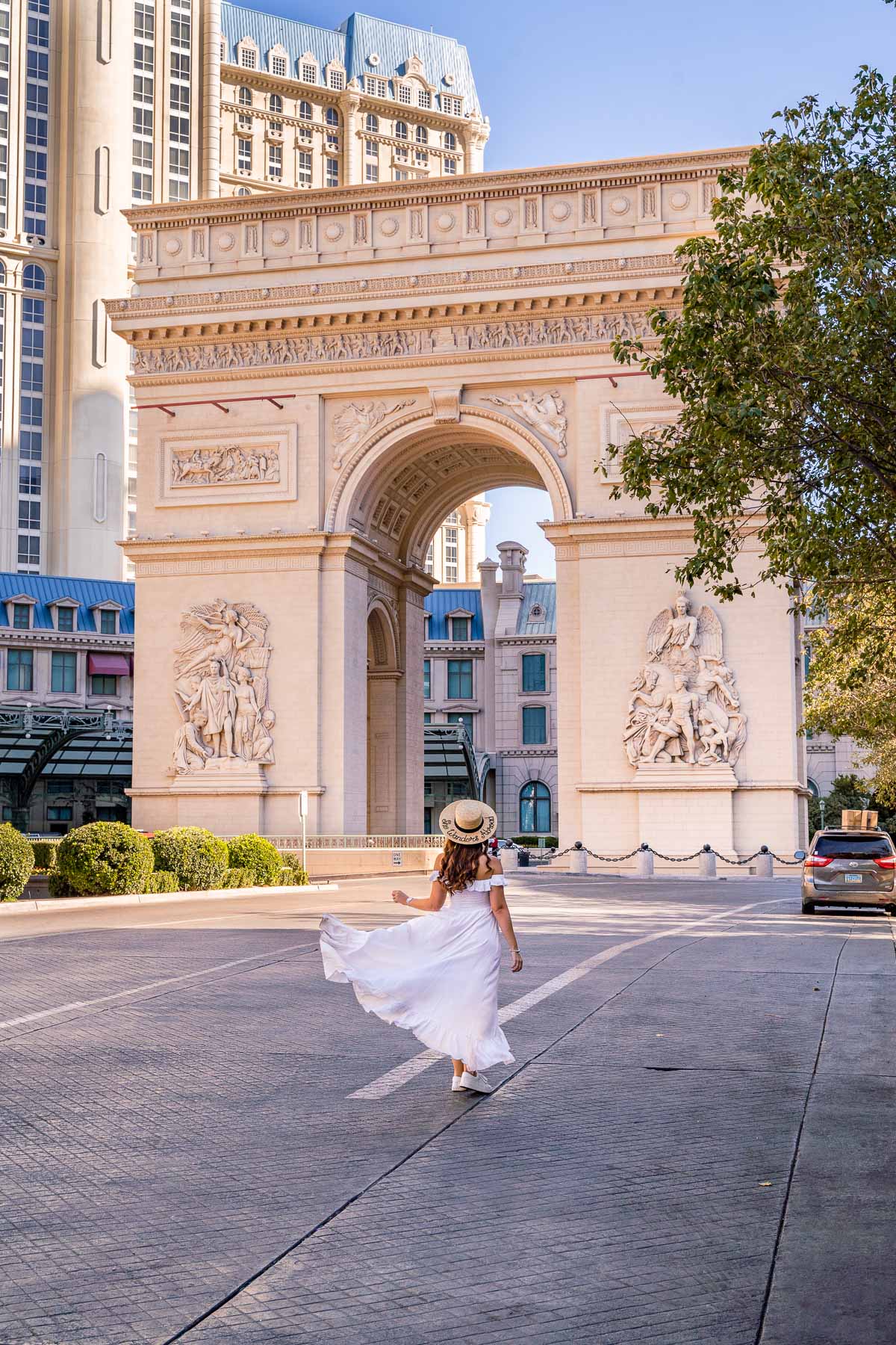 Girl in white dress in front of the Arc de Triomphe in Las Vegas