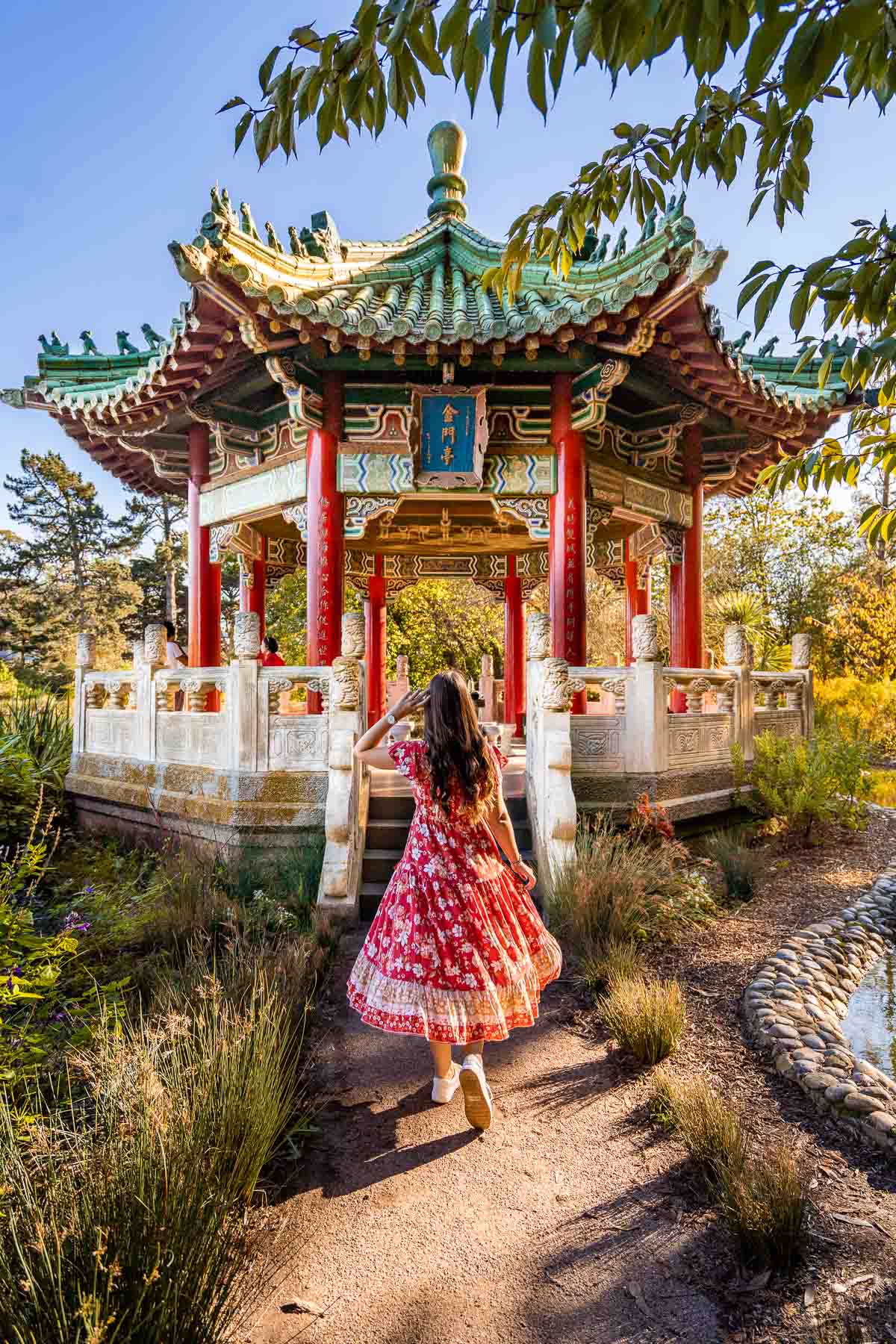 Girl in red dress in front of the Golden Gate Pavilion at Stow Lake