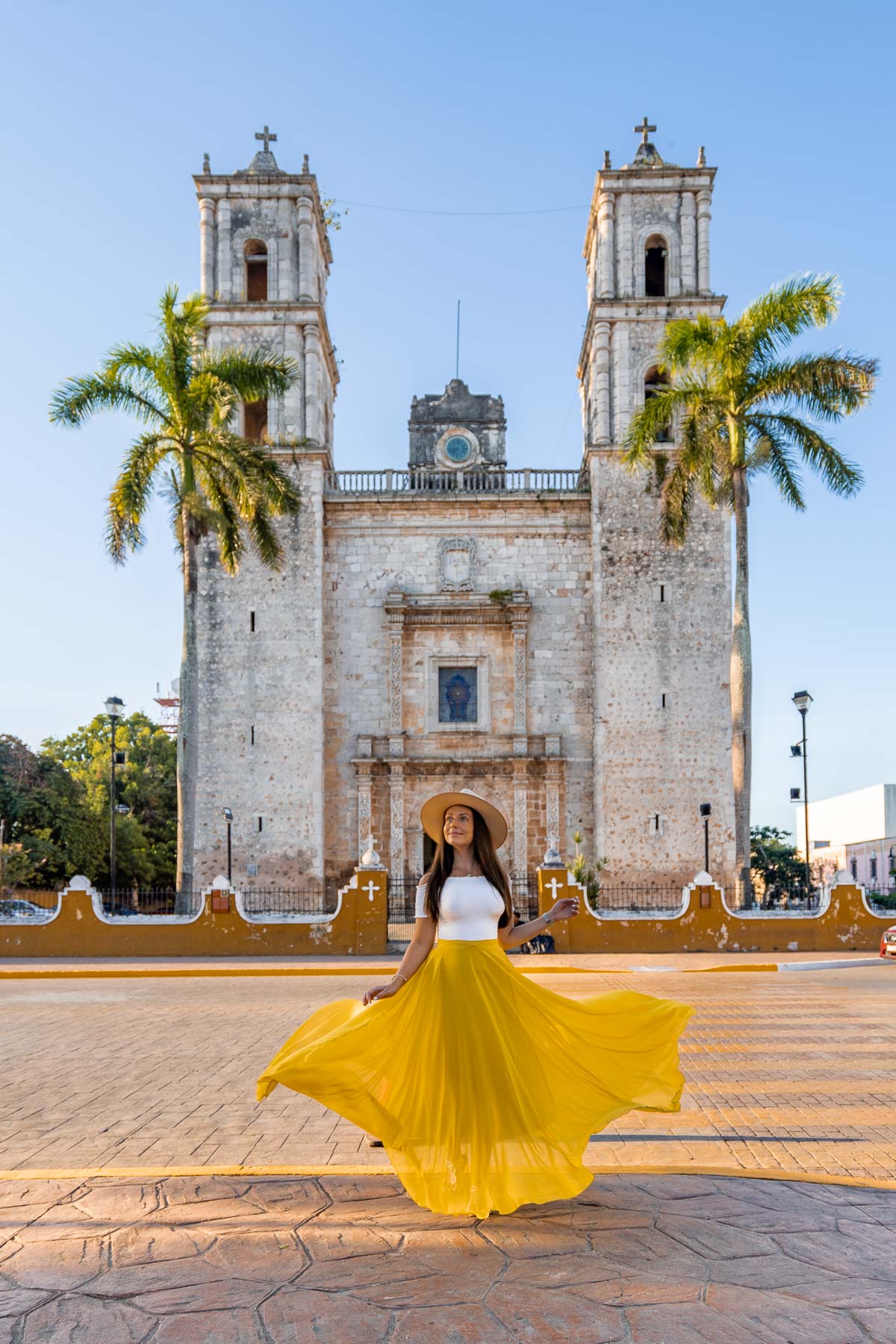 Girl in yellow skirt in front of Iglesia de San Servacio in Valladolid
