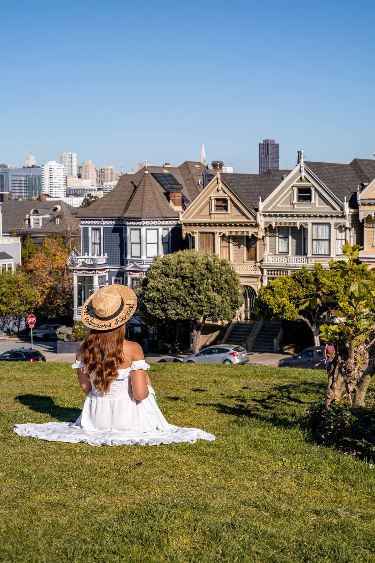Girl in white dress in front of the Painted Ladies in San Francisco
