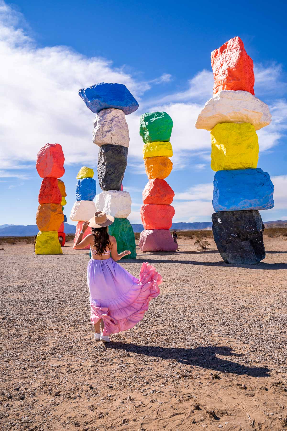 Girl in pink-purple dress at the Seven Magic Mountains in Nevada
