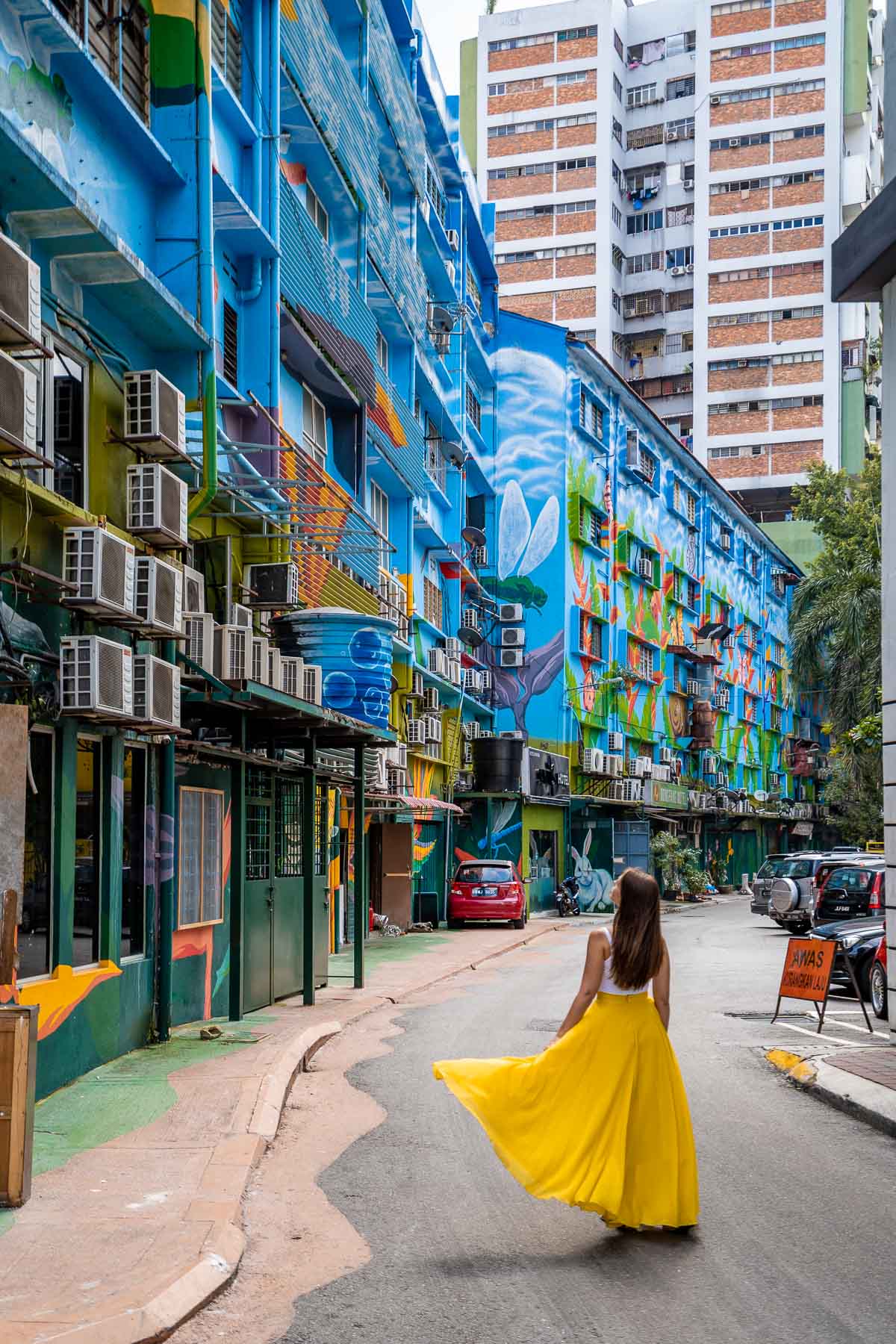 Colorful street art in Kuala Lumpur with girl in yellow skirt