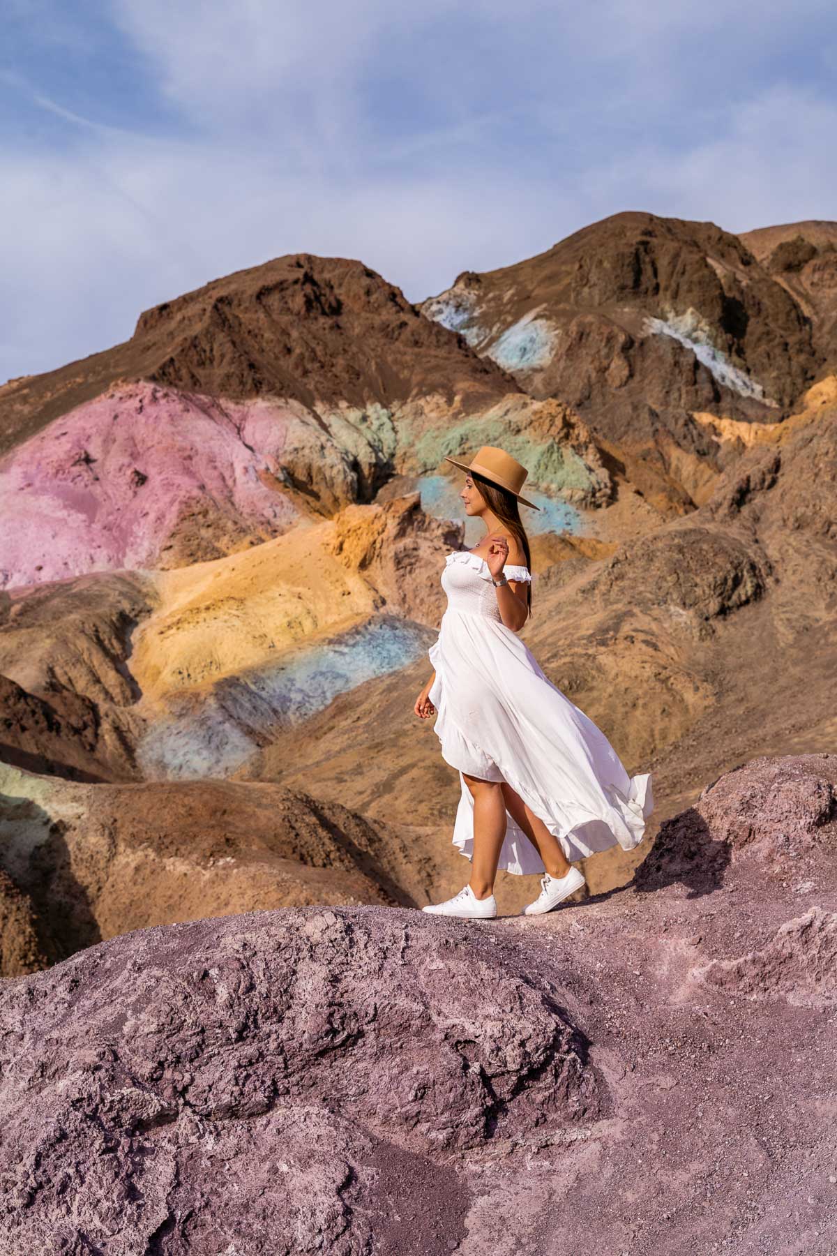 Girl in white dress at the The colorful rocks at Artist's Palette, Death Valley National Park