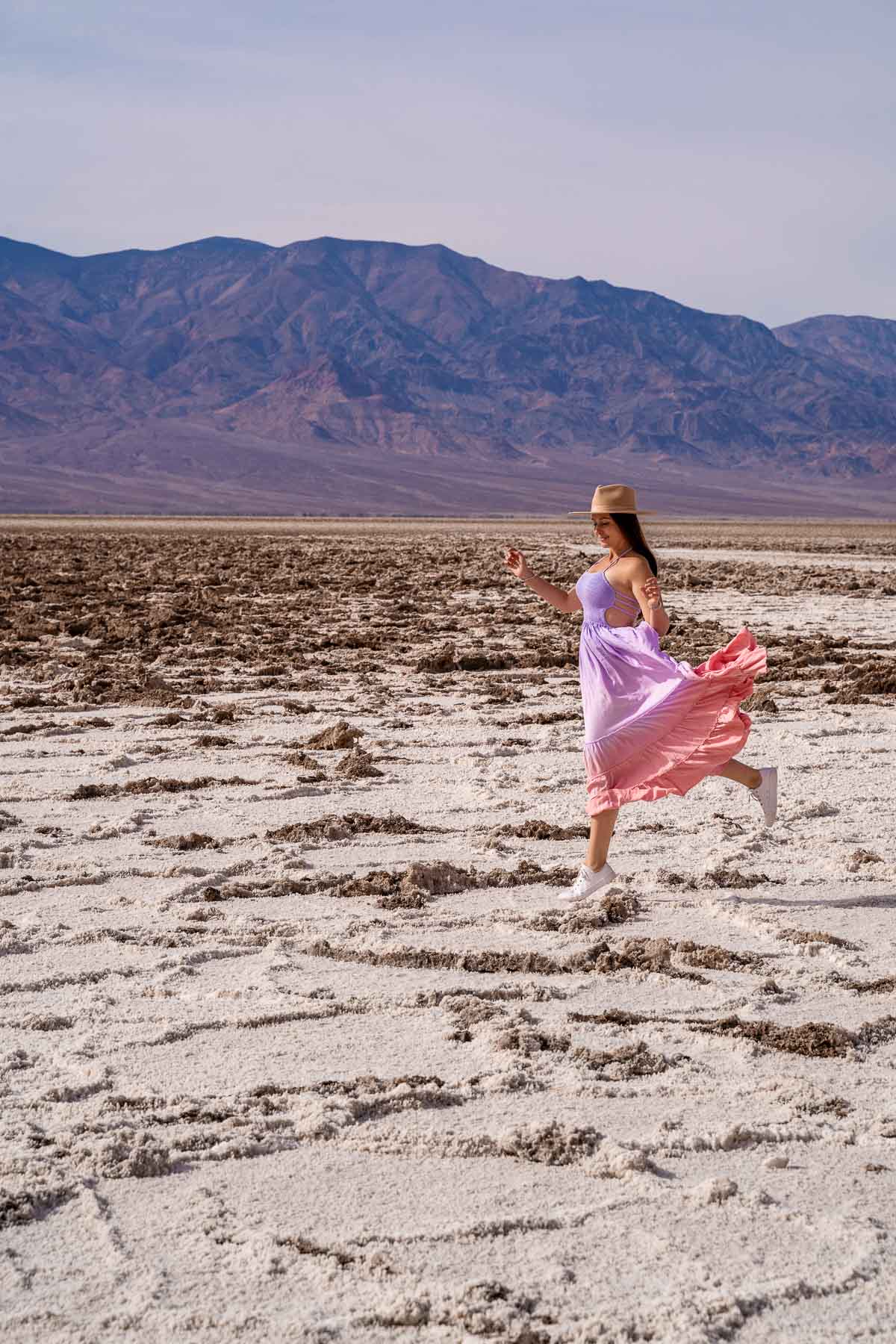 Girl in purple dress at the salt flats at Badwater Basin in Death Valley National Park