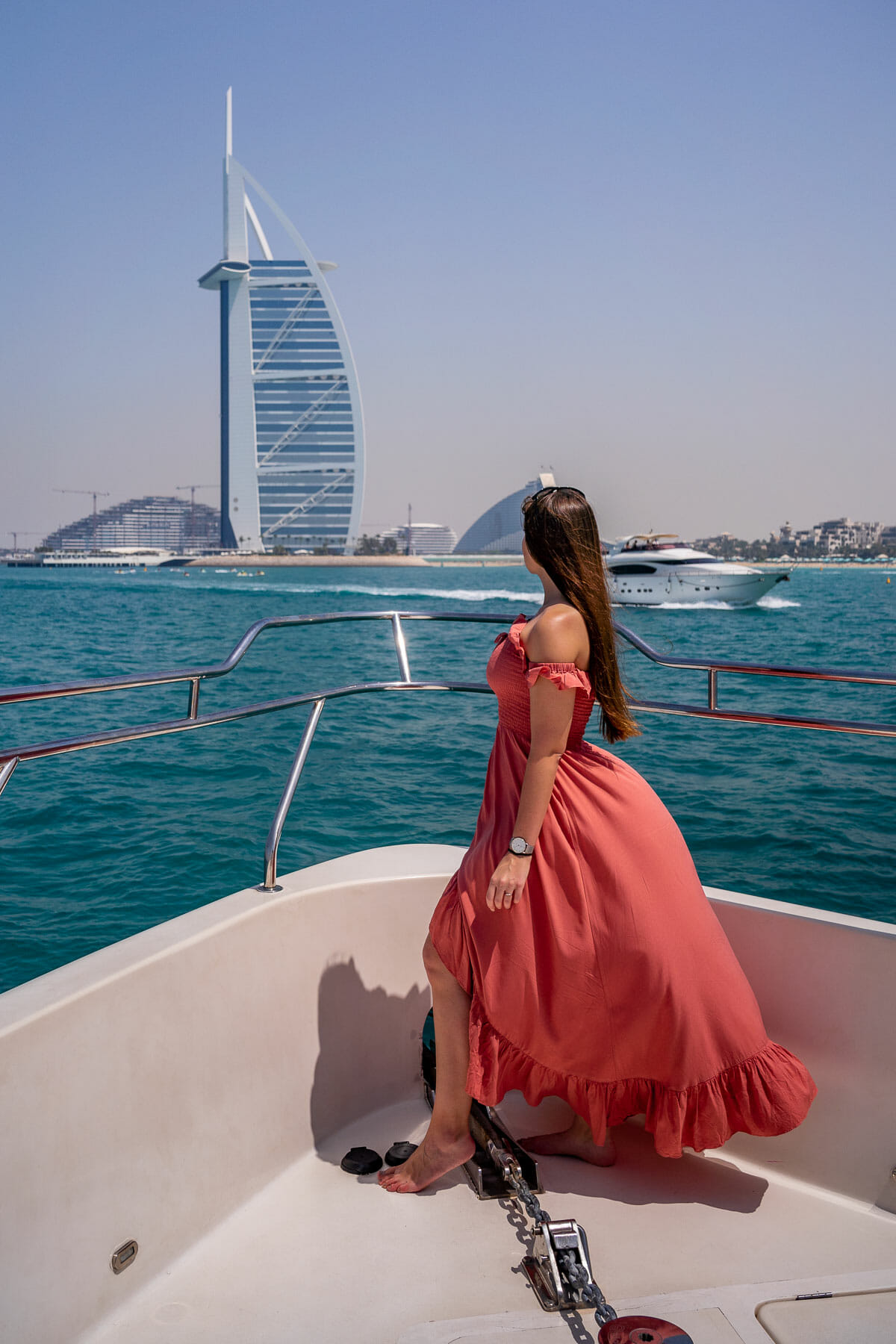 Girl on a yacht with Burj al Arab in the background