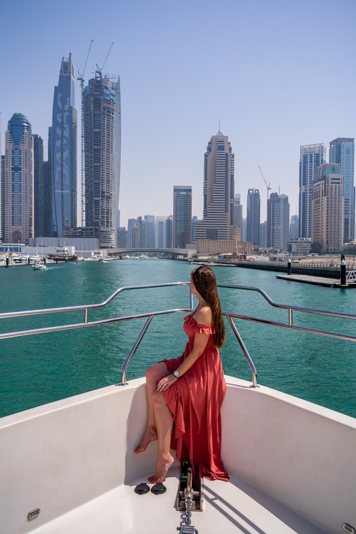 Girl on a yacht with Dubai Marina in the background
