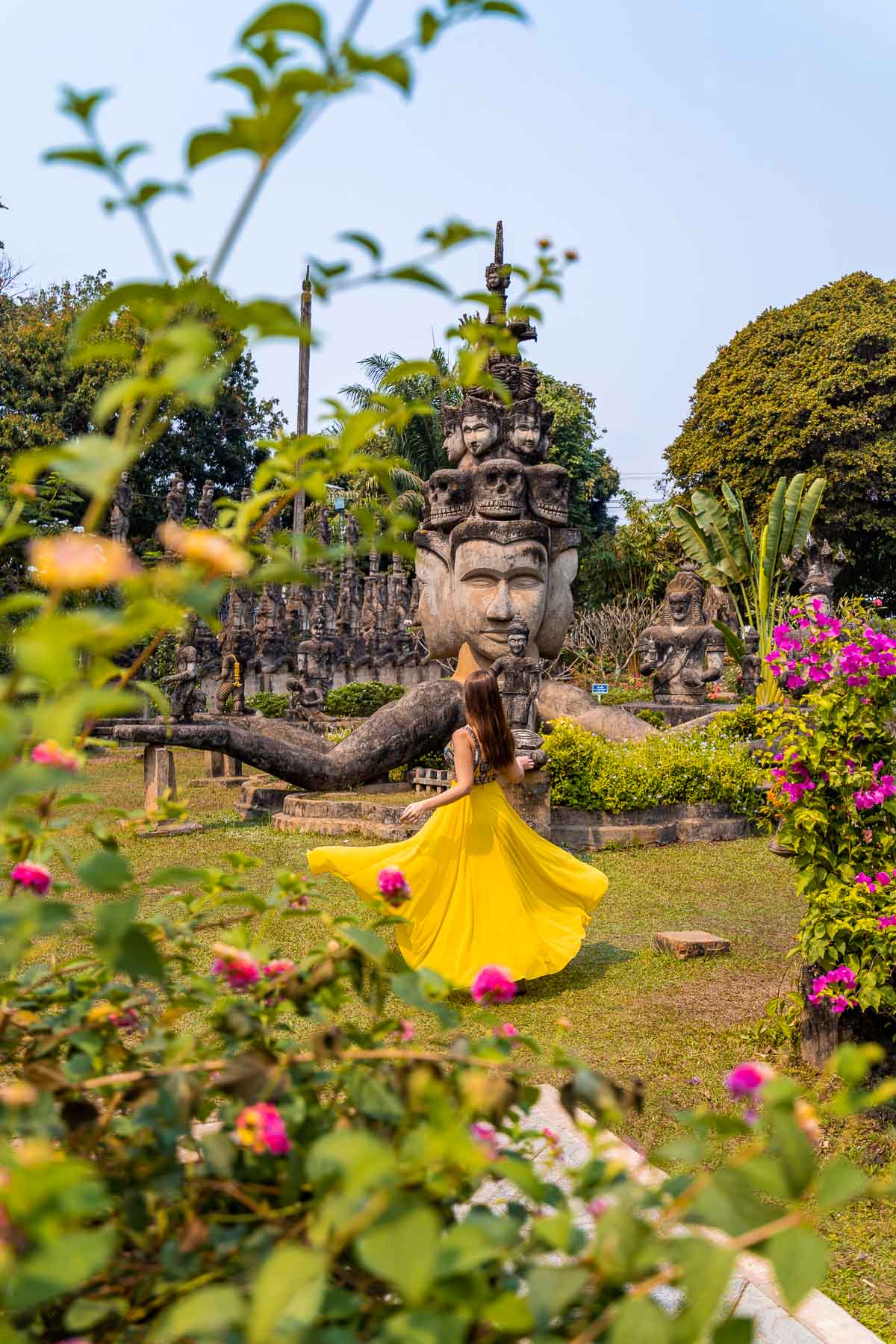 Girl in yellow skirt in the Buddha Park in Vientiane, Laos