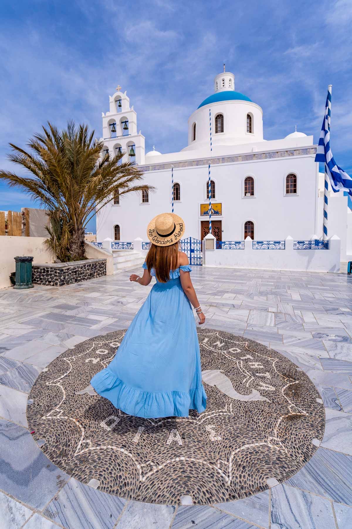 Girl in blue dress in front of Church of Panagia Akathistos Hymn in Oia, Santorini