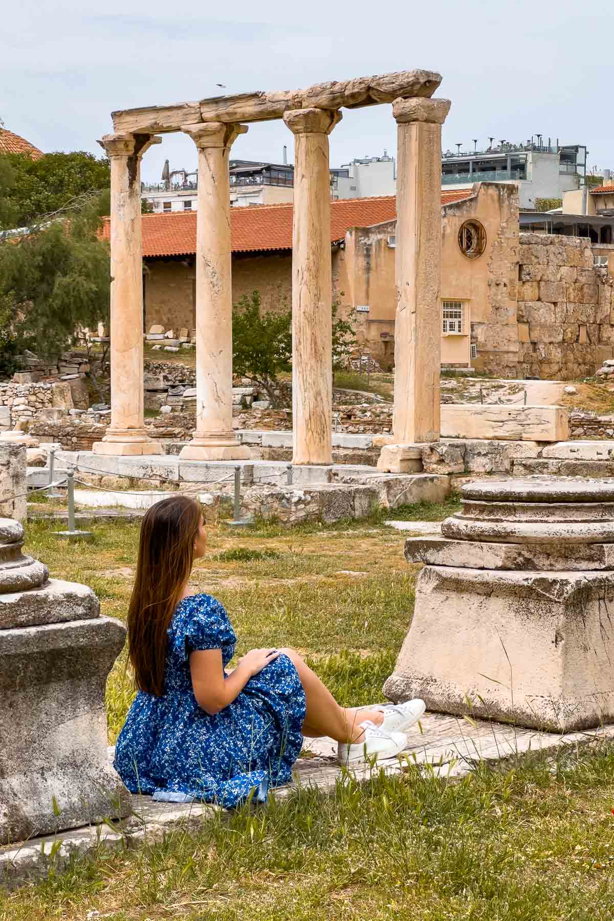Girl in blue dress sitting at Hadrian's Library, Athens