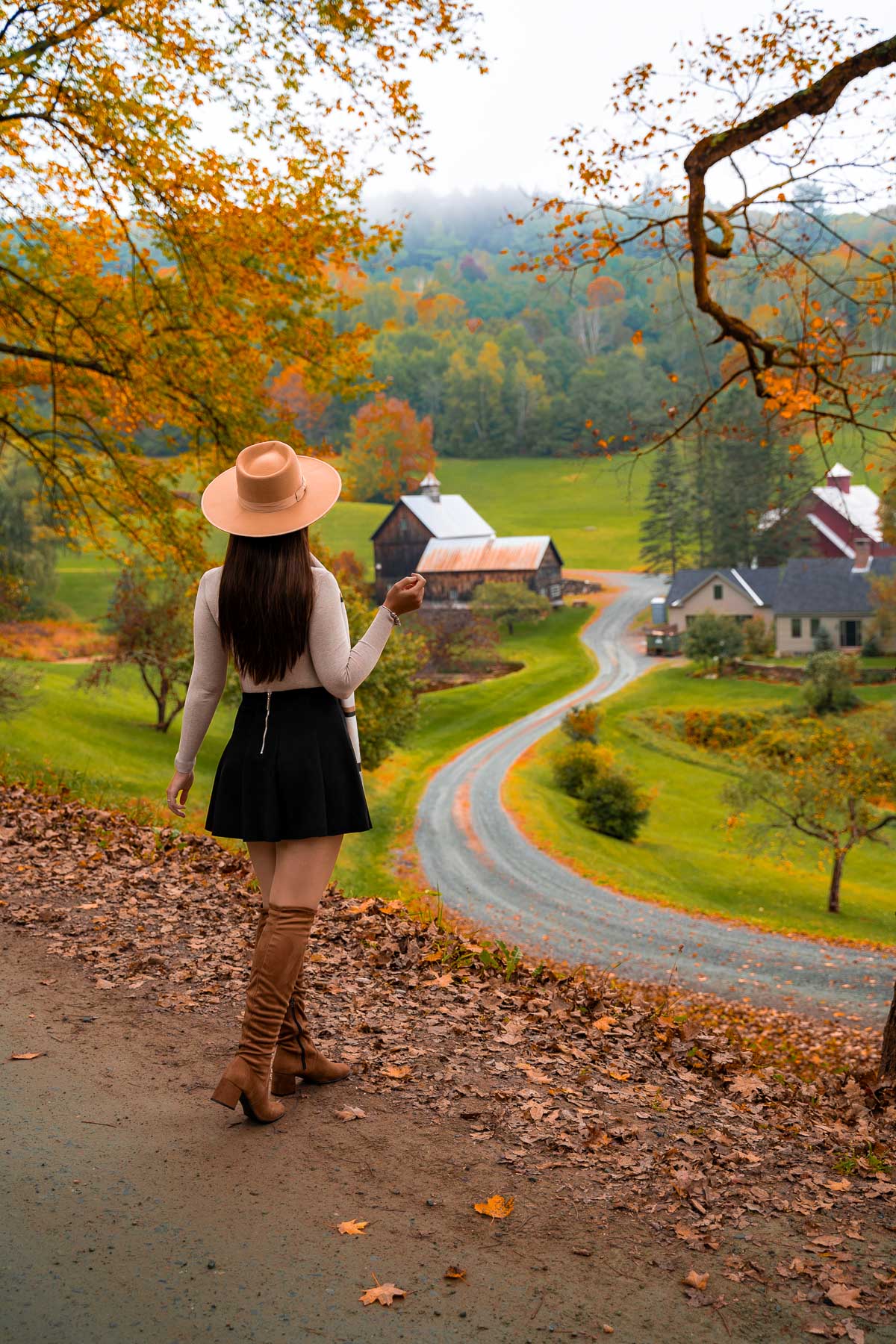 Girl in front of Sleepy Hollow Farm in Woodstock VT in the fall