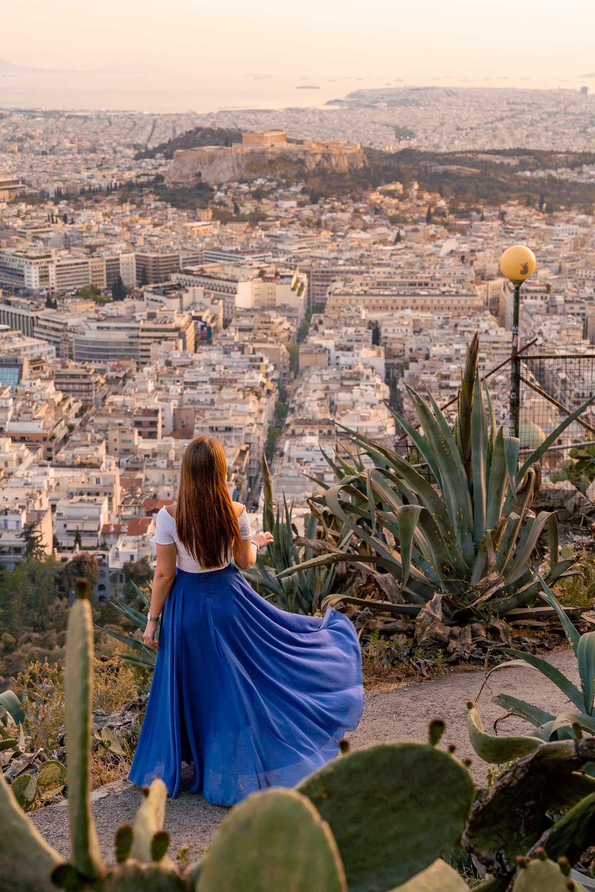 Girl in blue skirt watching the sunset from Lycabettus Hill, Athens