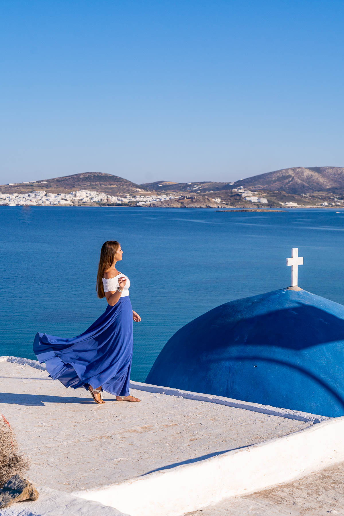 Girl in blue skirt at Monastery of St. John's of Deti in Paros