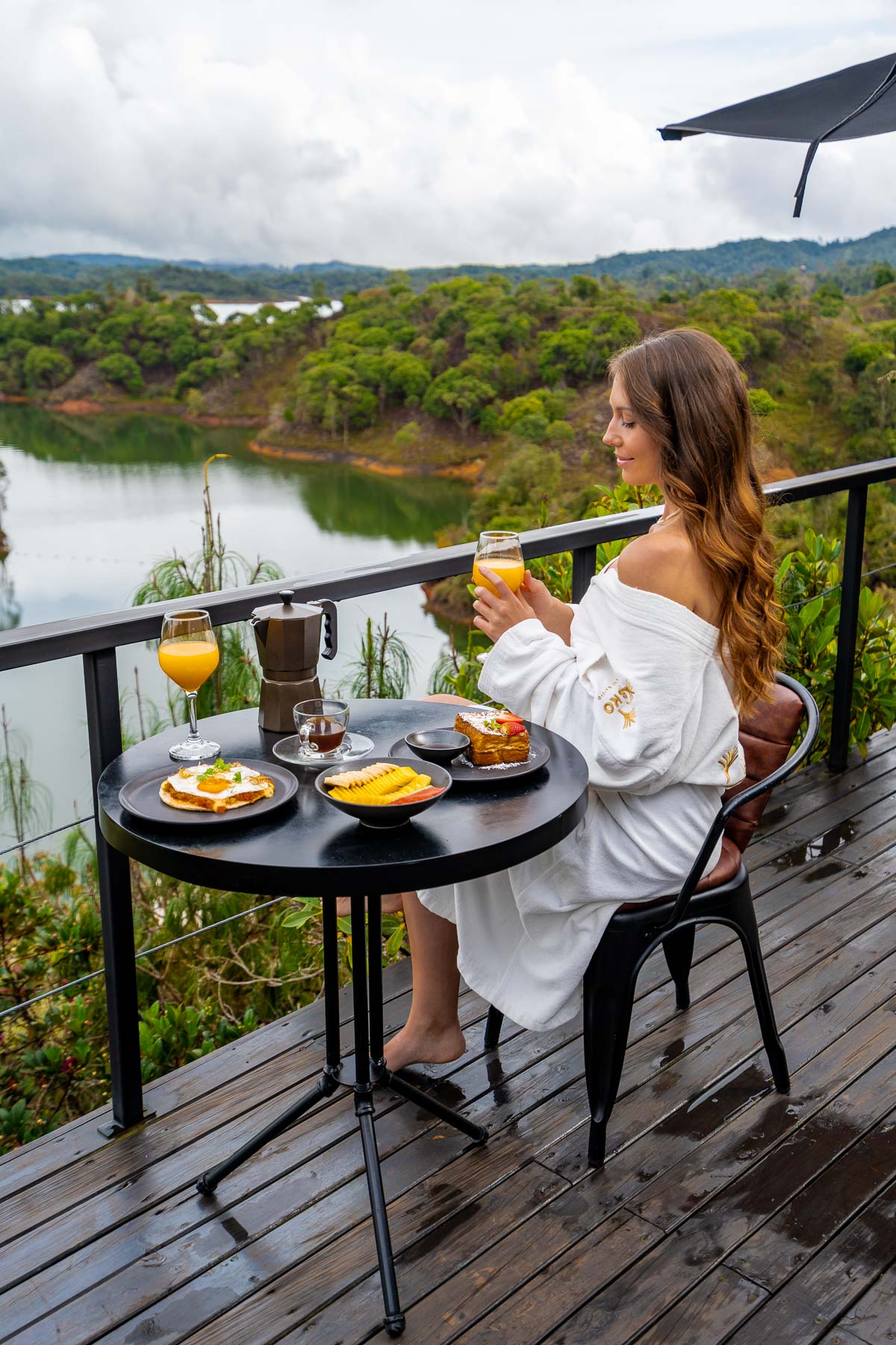 Girl having breakfast on the terrace at Bosko Guatape