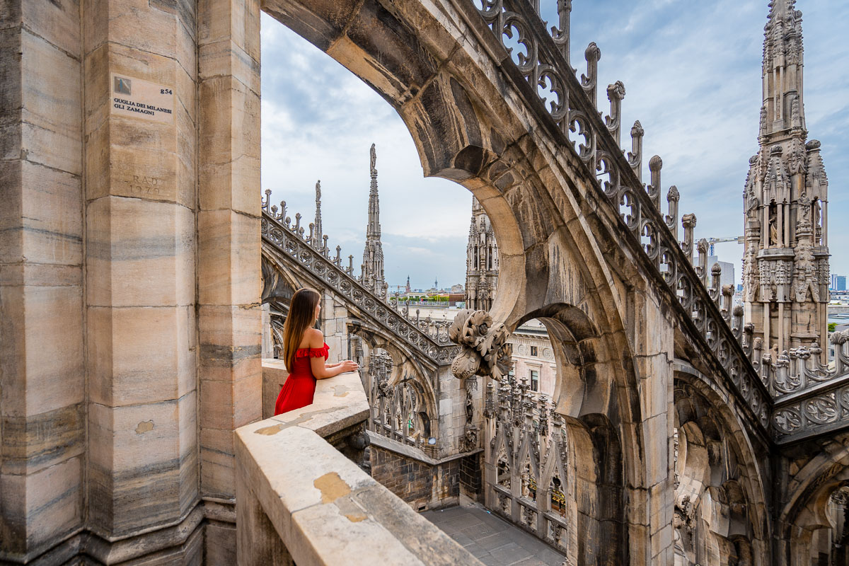 Girl in red dress at the Duomo di Milano Rooftop
