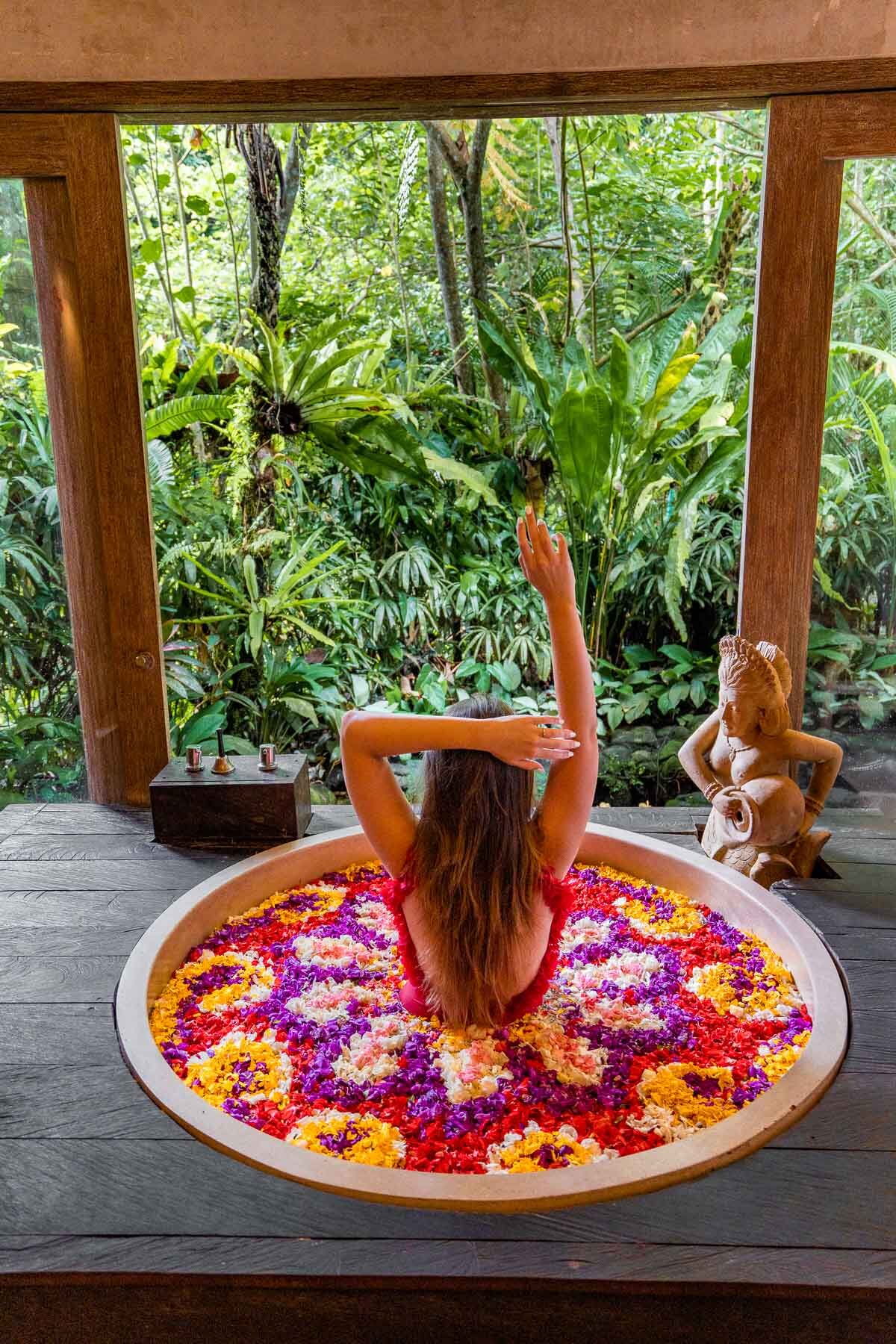 Girl in a flower bath at Kaveri Spa, The Udaya Bali