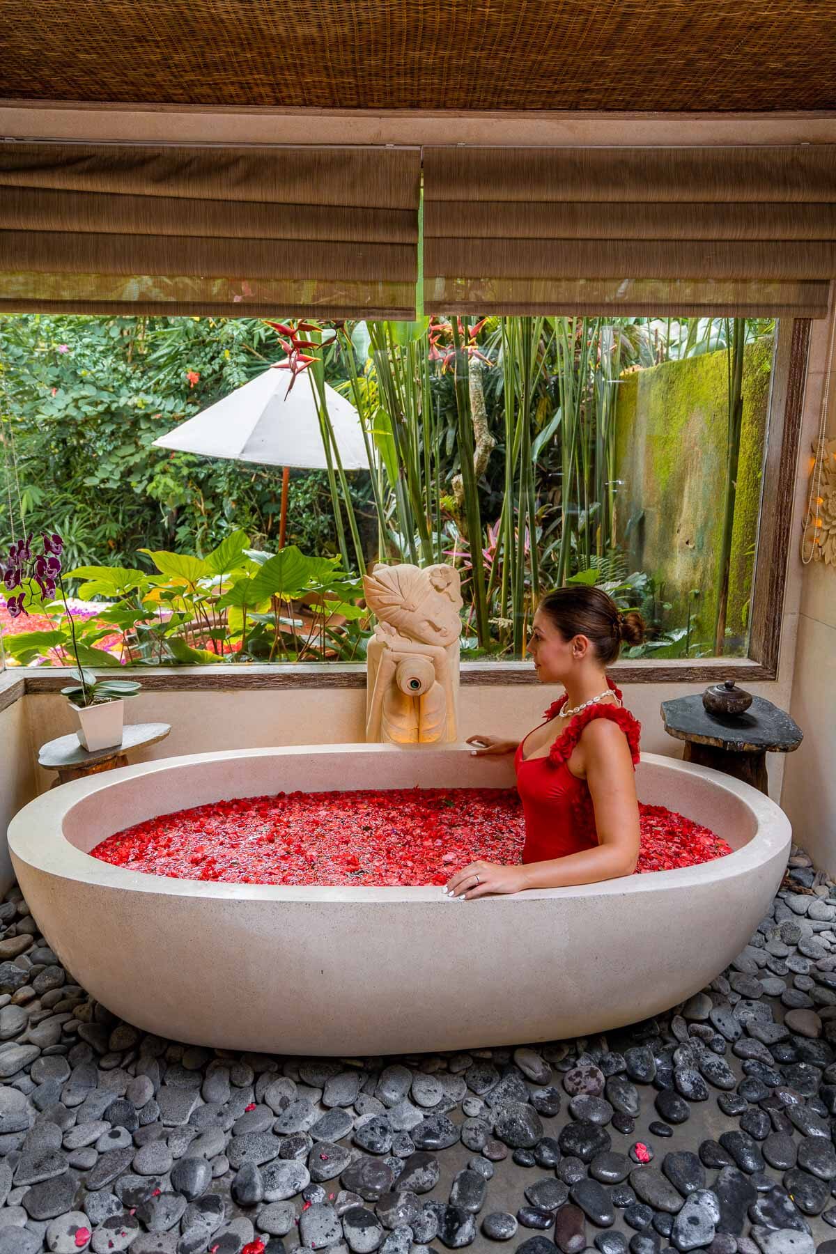 Girl in a flower bath at a Pool Villa at The Udaya