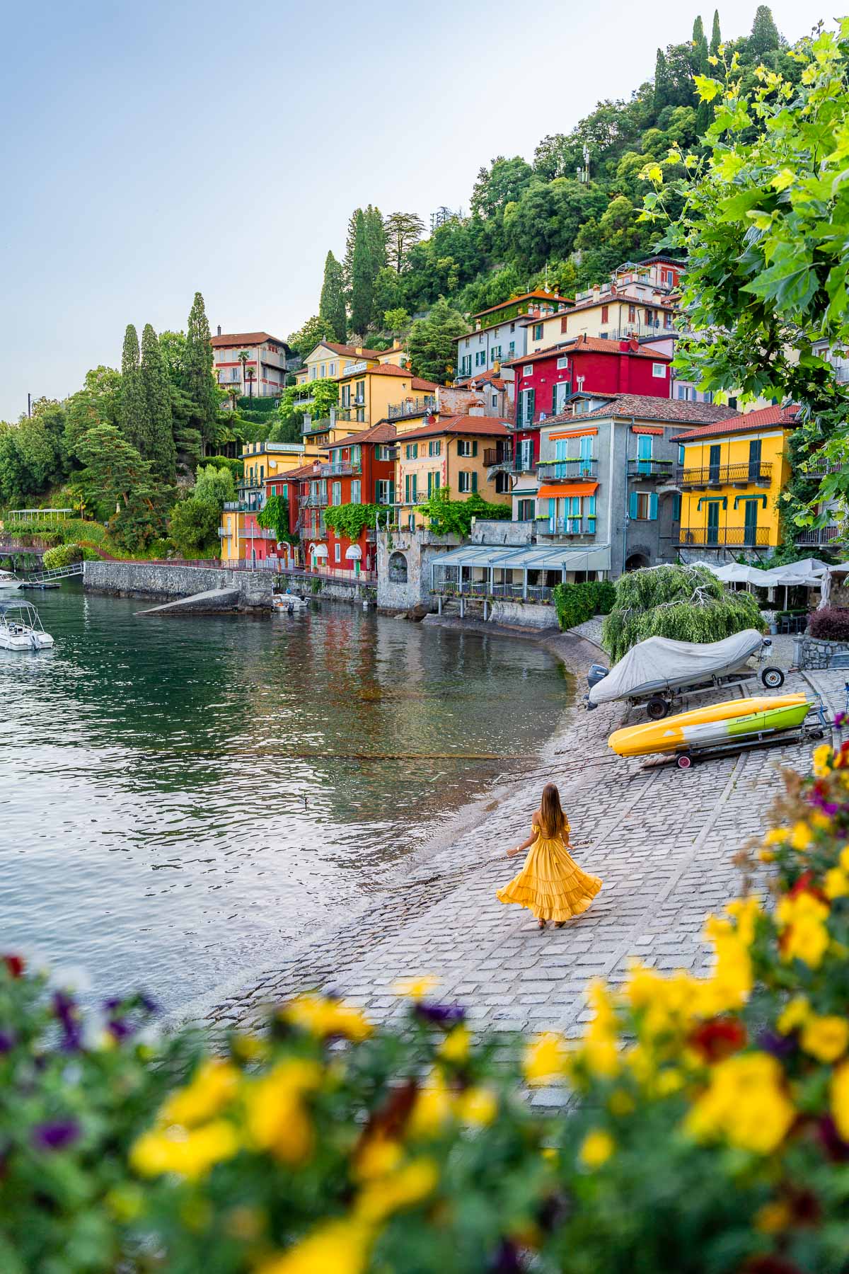 Girl in yellow dress in front of the colorful houses in Varenna, Lake Como