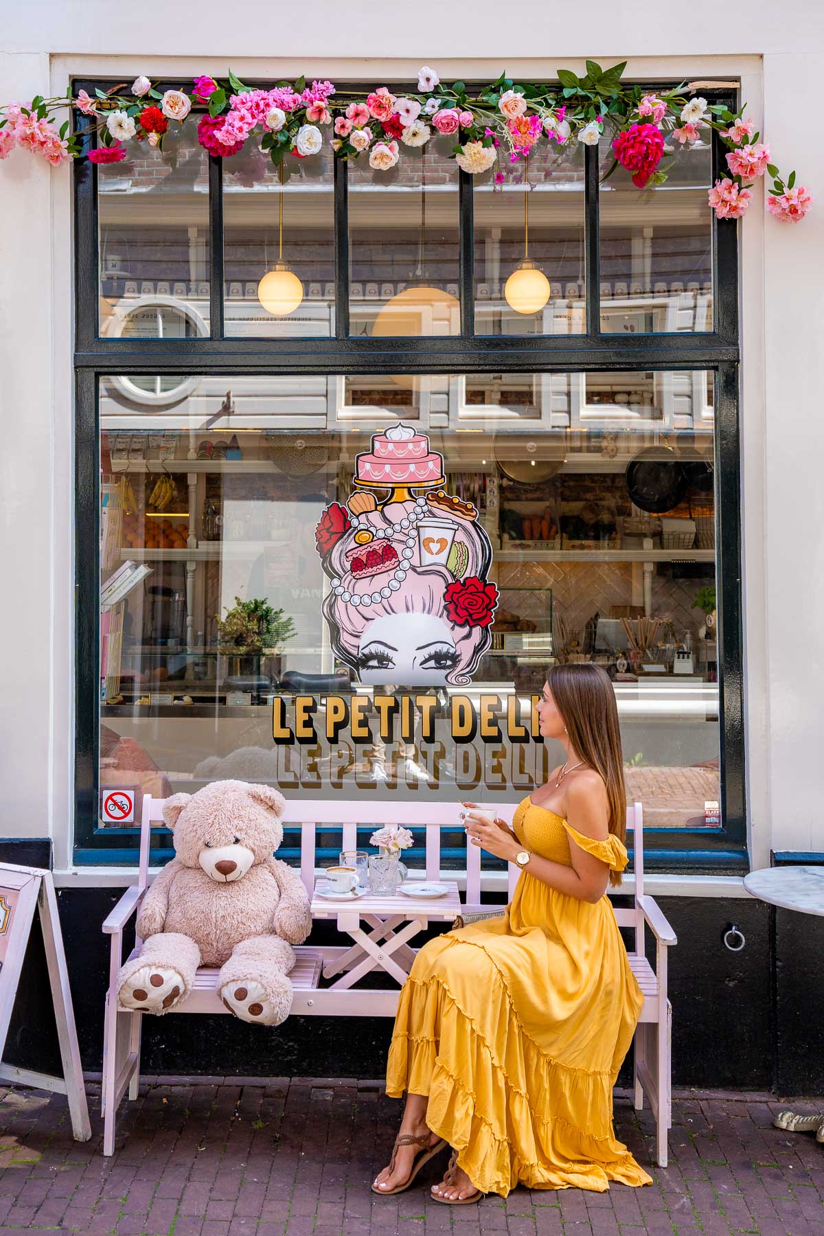 Girl in yellow dress in front of Le Petit Deli