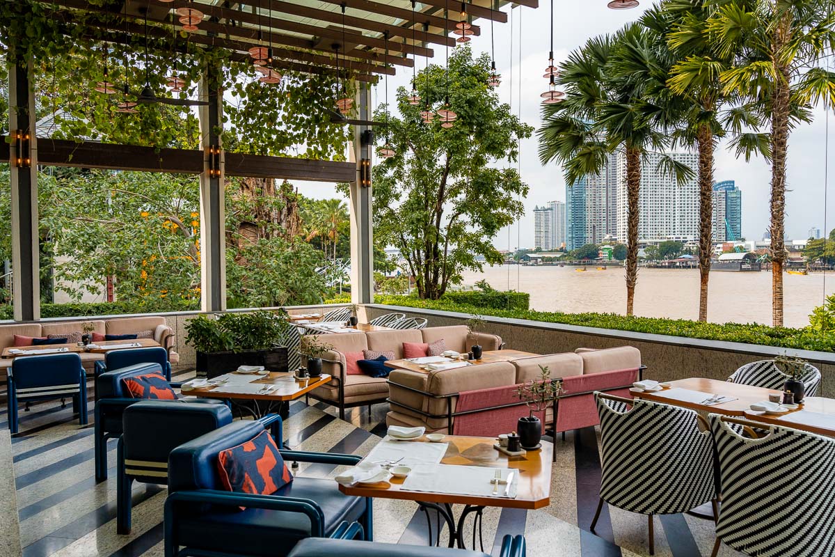 Outdoor seating area at Riva del Fiume at Four Seasons Hotel Bangkok