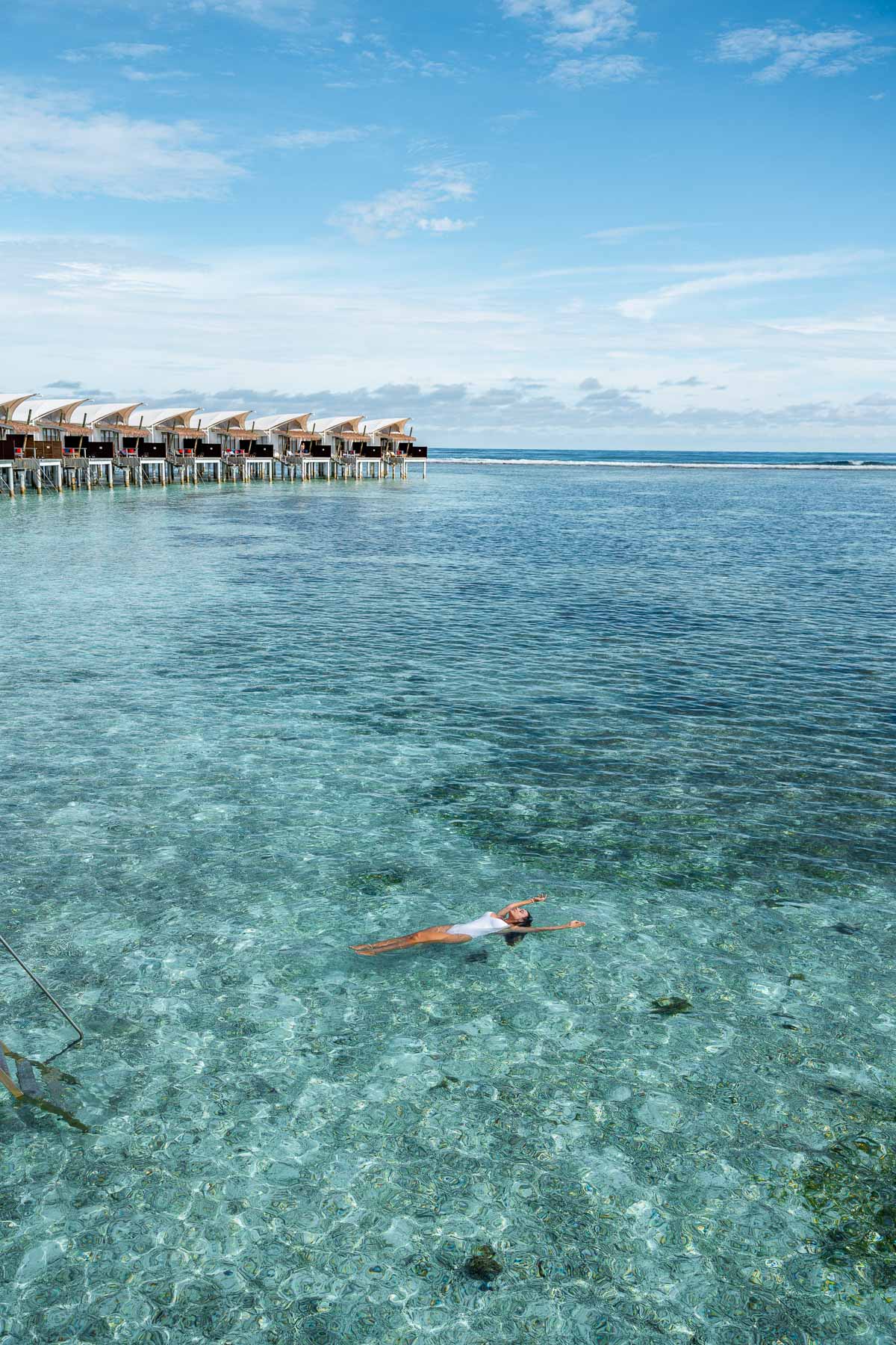 Girl floating in the water at Cinnamon Hakuraa Huraa Maldives