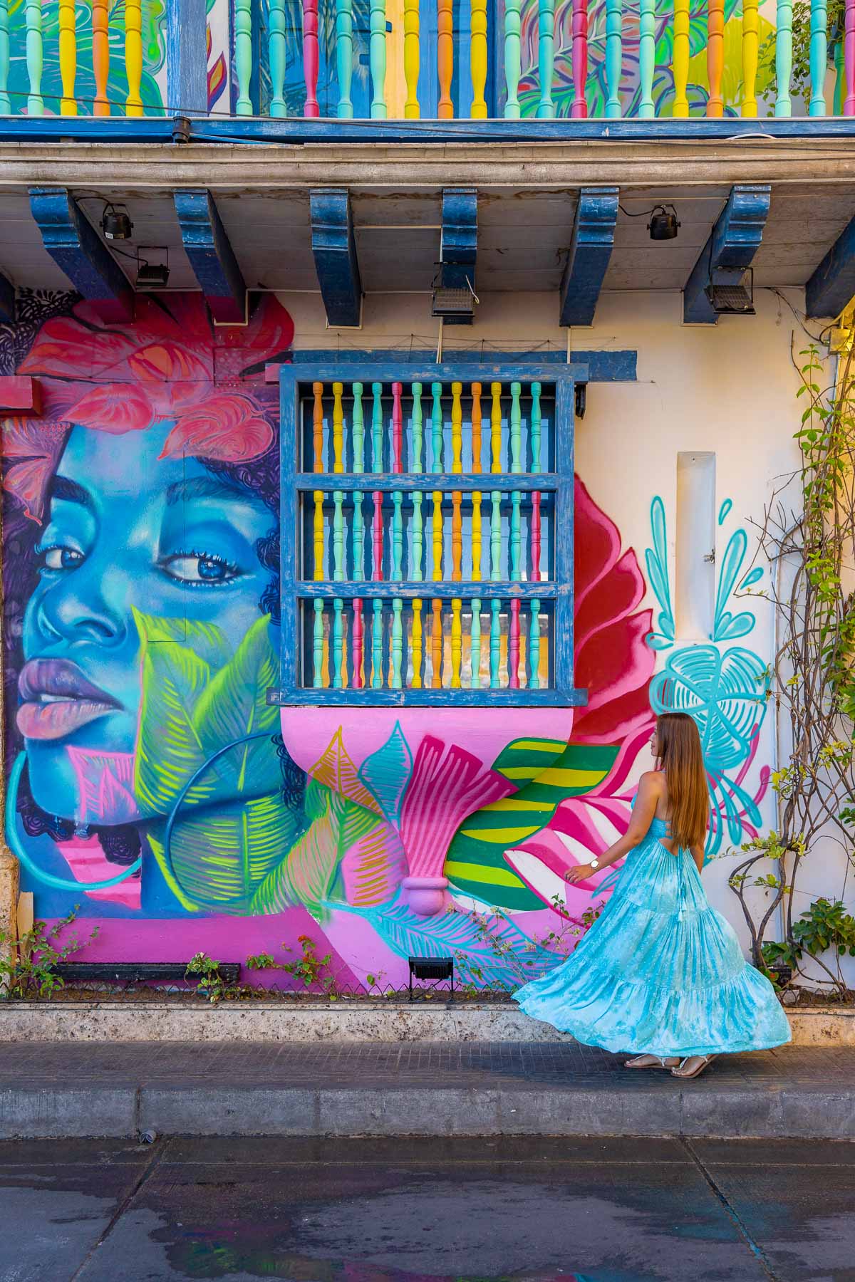Girl in front of a colorful mural in Getsemani, Cartagena
