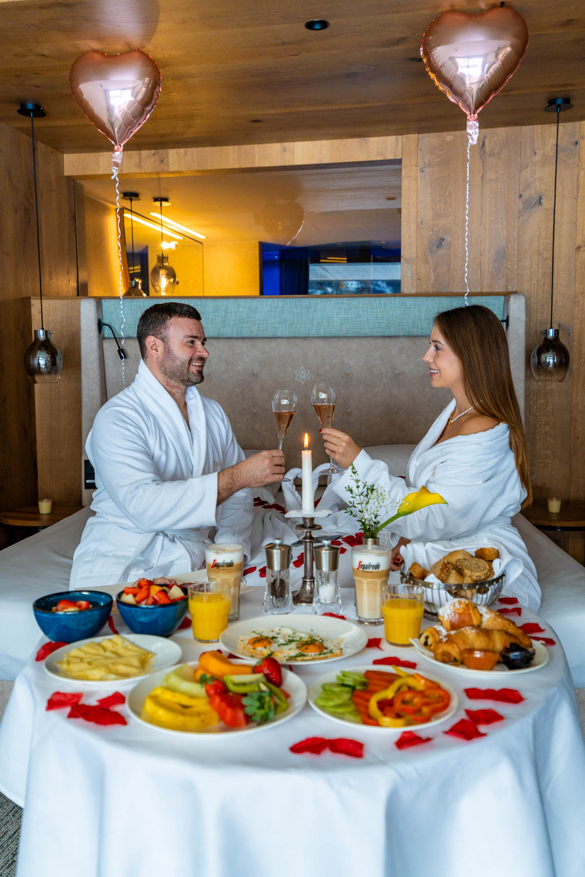Couple having in room breakfast at Das Edelweiss Salzburg Mountain Resort