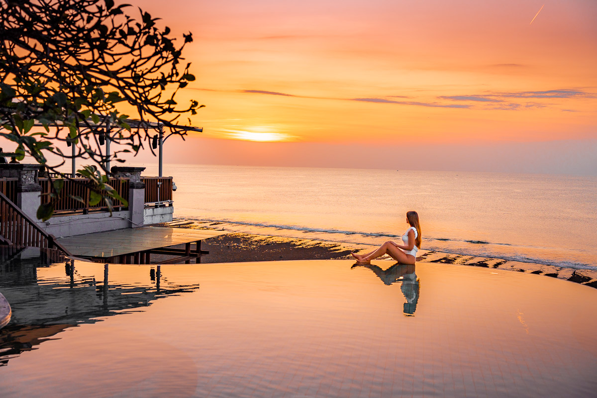 Girl by the pool at sunset at Anantara Uluwatu Bali Resort