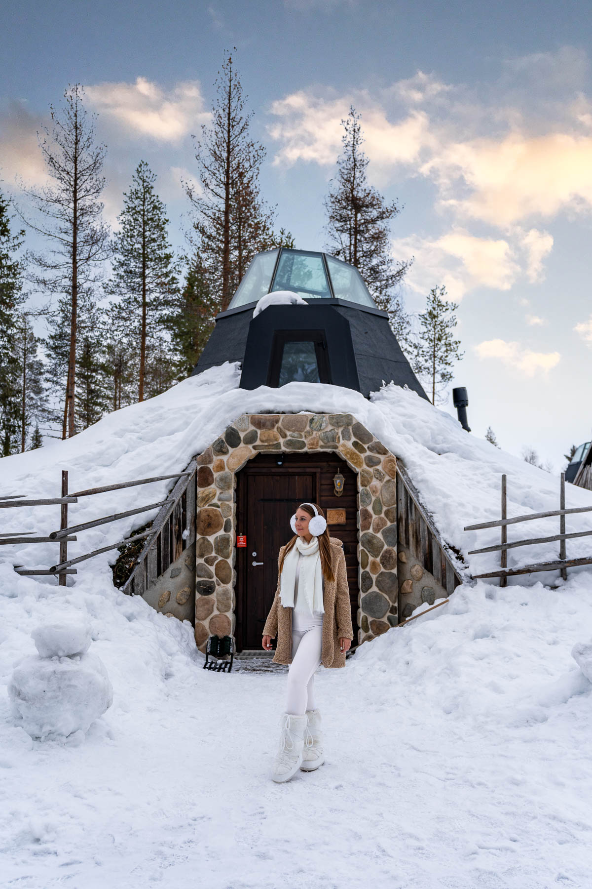 Girl in front of a Kammi Glass Igloo Suite at Apukka Resort