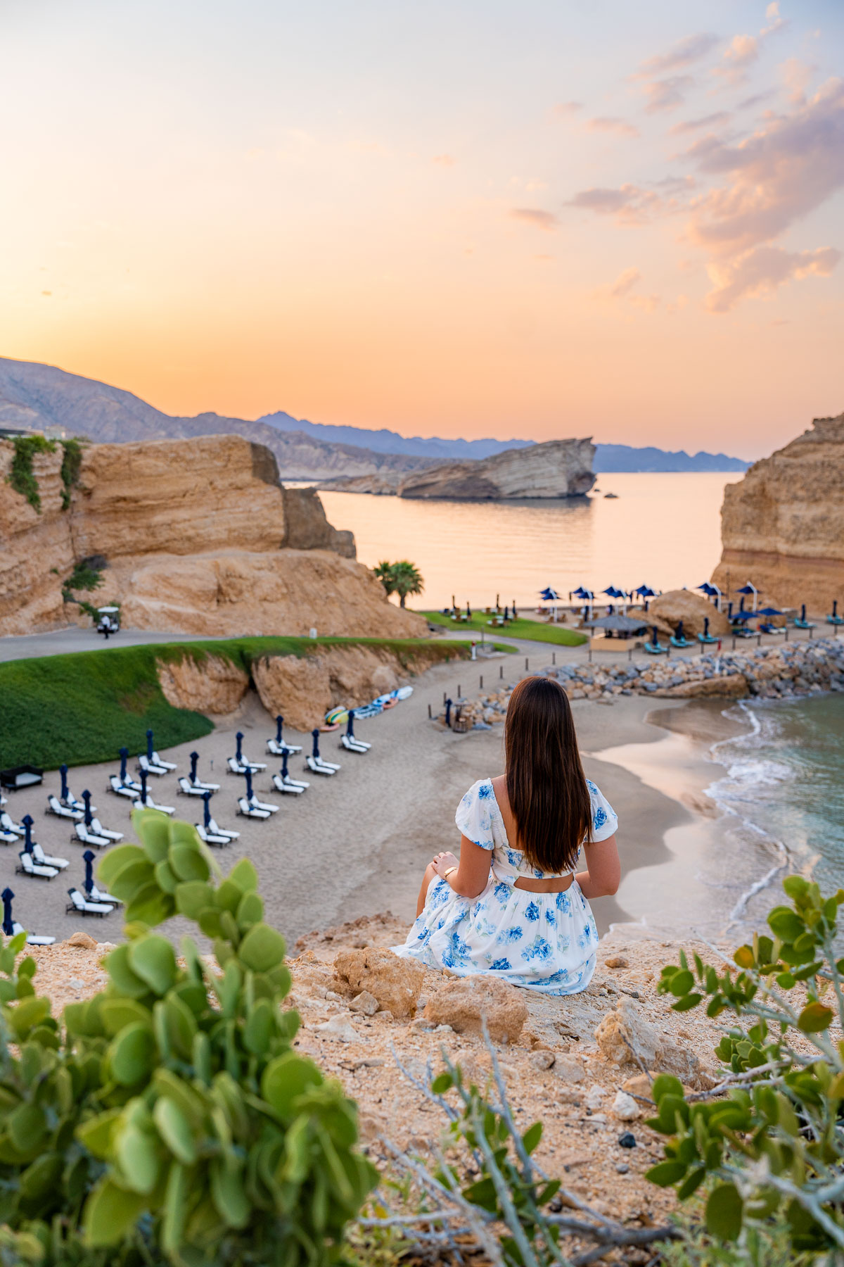 Girl watching the sunset on the private beach at Shangri-La Al Husn