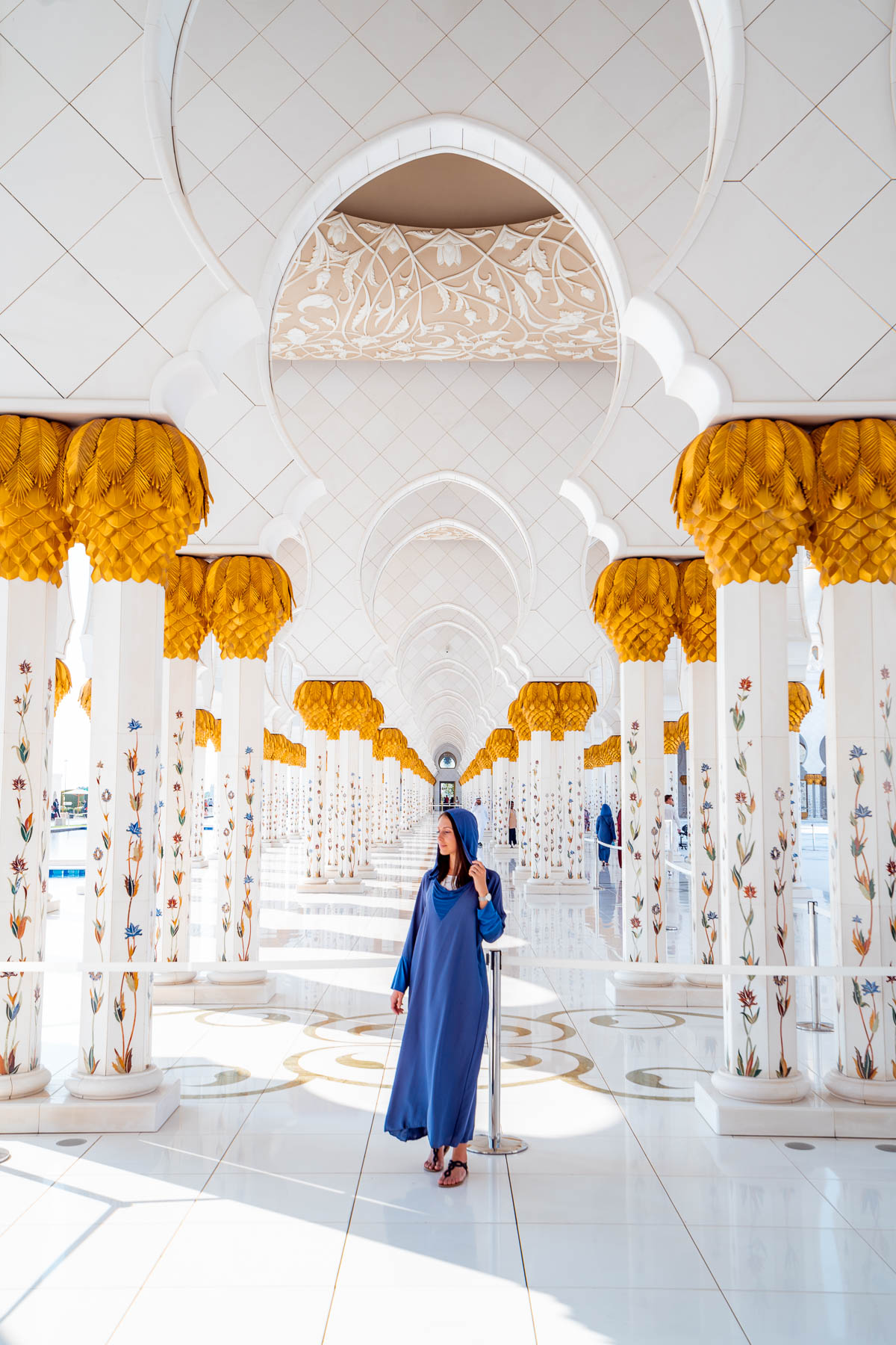 Girl in blue abaya standing in Sheikh Zayed Grand Mosque, Abu Dhabi