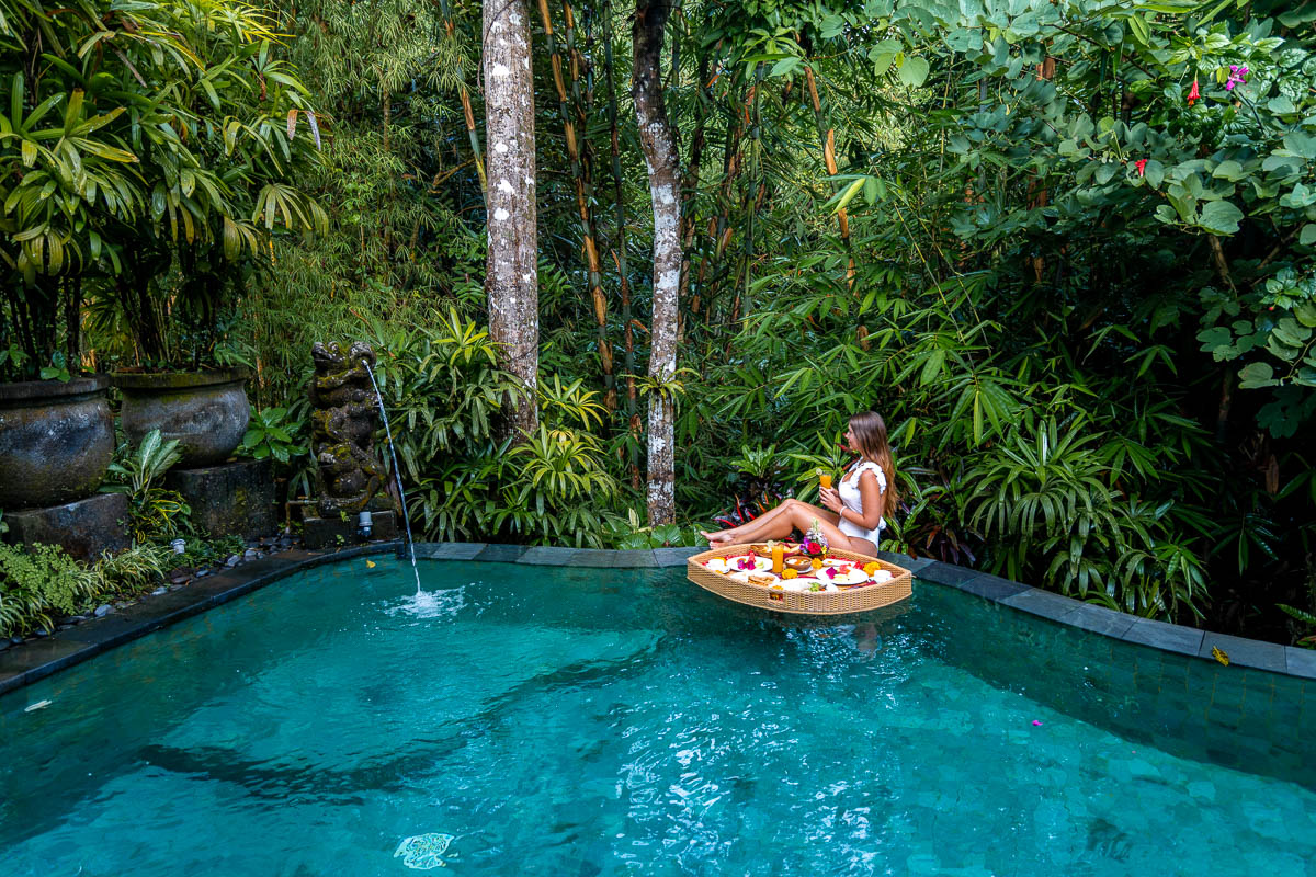 Girl with a floating breakfast in a private pool villa at The Udaya in Ubud, Bali