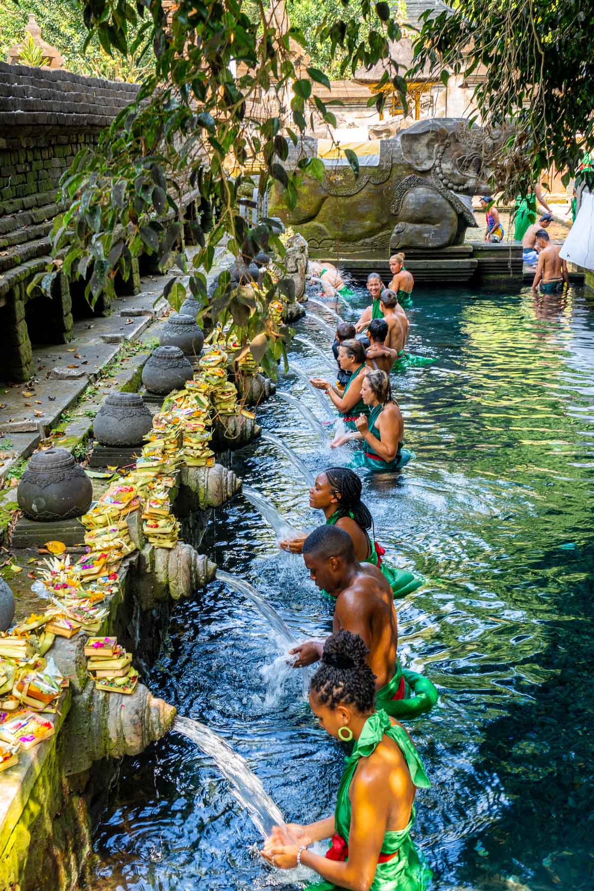People doing a cleansing ritual in the water at Pura Tirta Empul, Bali